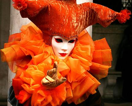 Venetian festival costume with orange ruff and mask.
