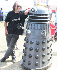 Man with arm wrapped around a dalek's shoulders